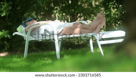 Senior man resting outside sleeping Royalty-Free Stock Photo #2303716585