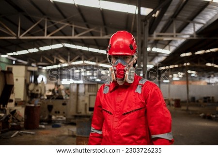 Portrait industry worker with safety uniform protective wearing gas mask to safe before start work to check chemical or gas in factory is industry safety concept.  Royalty-Free Stock Photo #2303726235