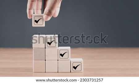 Checklist concept, Check mark on ladder stack wooden blocks, Survey and assessment, Task list, Quality Control, Goals achievement and business success. Elections and Voting, Vote, to do list.