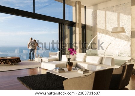 Couple standing on balcony of modern house Royalty-Free Stock Photo #2303731687
