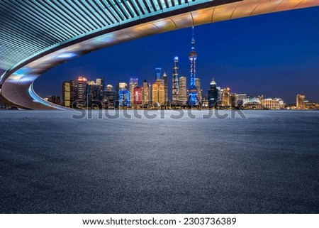 Asphalt road and city skyline with modern buildings scenery at night in Shanghai, China.