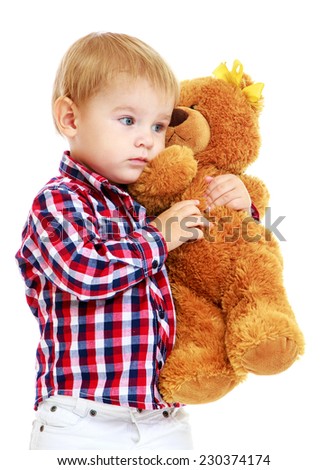 Little boy is playing in the kindergarten with a teddy bear.Early years learning a happy childhood concept.Isolated on white background.