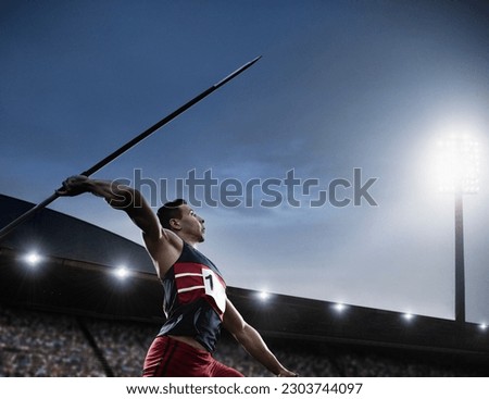 Track and field athlete throwing javelin Royalty-Free Stock Photo #2303744097