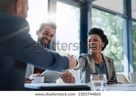 Meeting, partnership and business people shaking hands in the office for a deal, collaboration or onboarding. Diversity, professional and employees with handshake for agreement, welcome or greeting. Royalty-Free Stock Photo #2303744865