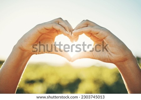 Girl with heart hands, nature and sunshine, sustainability and eco friendly earth care and natural farm landscape. Conservation, sustainable farming and love hand sign emoji, woman with green fingers