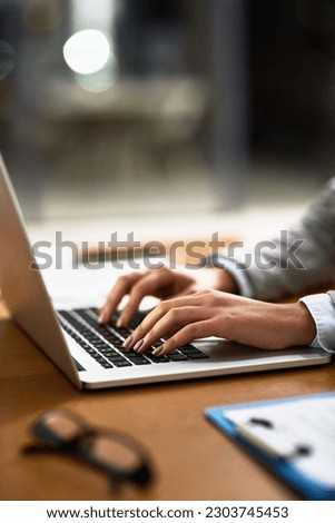 Laptop, email and hands of a person at a desk for work, internet and connection at night. Business, corporate and a secretary or receptionist typing on a computer for late admin online in an office Royalty-Free Stock Photo #2303745453