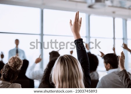 Conference, crowd and business people with hands for a question, vote or volunteering. Corporate event, meeting and hand raised in a training seminar for questions, voting or audience opinion Royalty-Free Stock Photo #2303745893