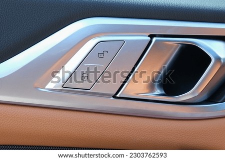 Lock unlock key button inside car door. Selective focus. 