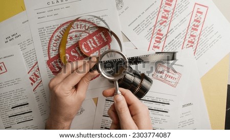 Magnifying glass shows confidential film