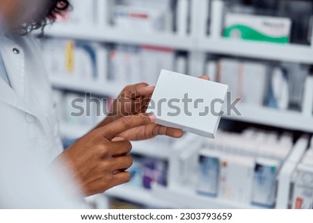 Focus on the box of medicine, female pharmacist showing that to a customer. Royalty-Free Stock Photo #2303793659