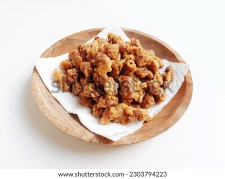 Delicious Indonesian snack peanut. Kacang Telur Medan or Medan Egg Beans are a nut wrapped in flour, eggs and spices, which are fried, have a textured shape, with a crunchy, crispy and savory taste. Royalty-Free Stock Photo #2303794223