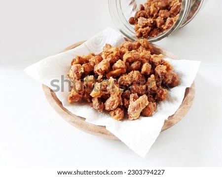 Delicious Indonesian snack peanut. Kacang Telur Medan or Medan Egg Beans are a nut wrapped in flour, eggs and spices, which are fried, have a textured shape, with a crunchy, crispy and savory taste. Royalty-Free Stock Photo #2303794227