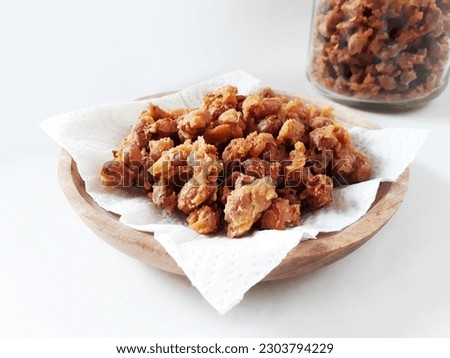 Delicious Indonesian snack peanut. Kacang Telur Medan or Medan Egg Beans are a nut wrapped in flour, eggs and spices, which are fried, have a textured shape, with a crunchy, crispy and savory taste. Royalty-Free Stock Photo #2303794229