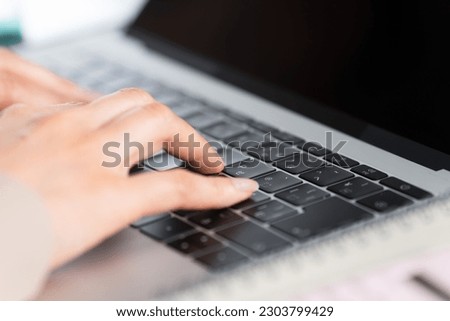 Young woman business image using a laptop Royalty-Free Stock Photo #2303799429