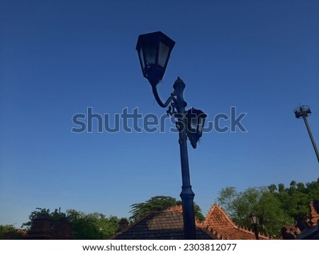 close up of garden lights (light poles)with blue sky background