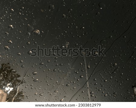 Rain drops on window windshield jaw drop in city at night travel