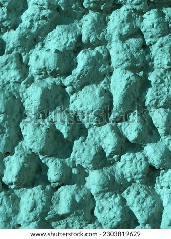 Abstract rough turquoise background.Fantastic cobblestone road. Top view. Grunge backdrop for creative design. Vertical photo.
