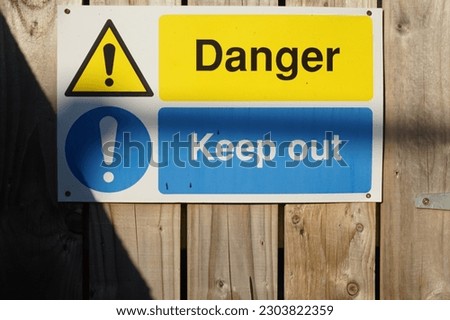 Danger Keep Out sign on a wooden fence