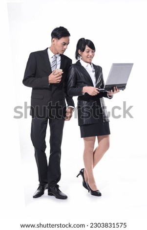 
Full length businessman and businesswoman using cellphone, laptop standing on white background
 Royalty-Free Stock Photo #2303831575