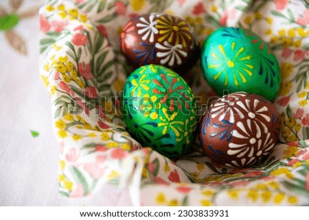 Four colorful Easter eggs in a bowl Painted with wax.