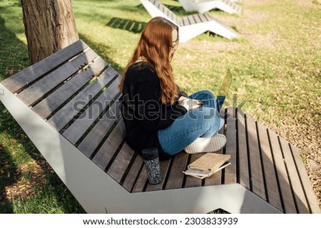 SMART Educational and life Goals for Students. Outdoor portrait of redhead student girl with laptop and backpack in city park