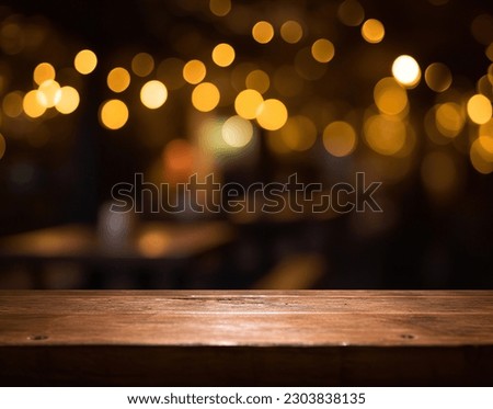 Empty wood table top on blur light gold bokeh of cafe restaurant Royalty-Free Stock Photo #2303838135