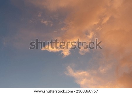 mystical pink clouds against a blue sky at sunset, reflection of sunlight, beautiful day