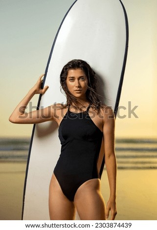 Girl surfer, vacation on Bali, Indonesia. Download a photo with copy space to advertise tours to a warm country. Surfing and vacation picture for social media promo.