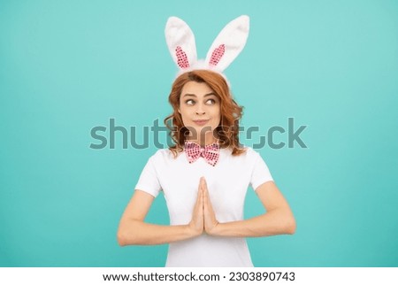 surprised easter woman with rabbit ears on blue background
