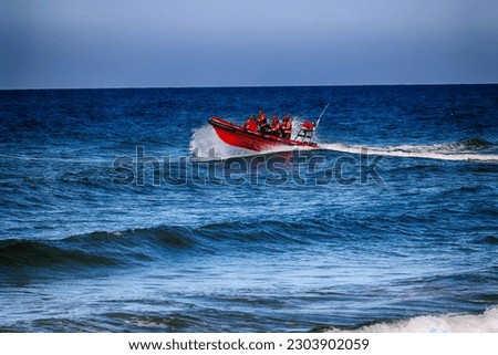 05.02.2023 rewal, poland, An orange boat with lifeguards is sailing with a rescue operation at sea. Royalty-Free Stock Photo #2303902059