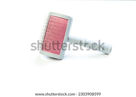Card, comb, knot cutter everything for the maintenance of our pets, dog, cat fur utensils Royalty-Free Stock Photo #2303908599