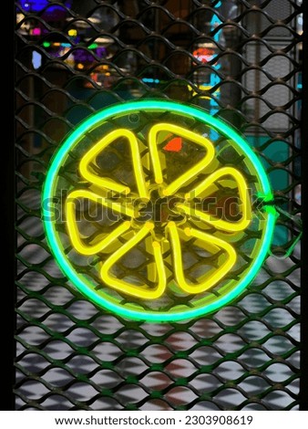 Illuminated Lemon. Bright colored collection of symbols or sign boards glowing with colorful neon light for cafe, restaurant, motel or cocktail bar. Template layout on grid background, copy space.