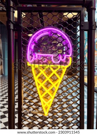 Illuminated Ice cream. Bright colored collection of symbols or sign boards glowing with colorful neon light for cafe, restaurant, motel or cocktail bar. Template layout on grid background, copy space.