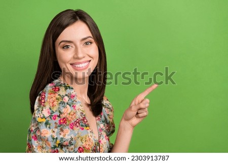 Portrait of young good mood lady wear flowers print blouse direct finger empty space tips for girls isolated on green color background
