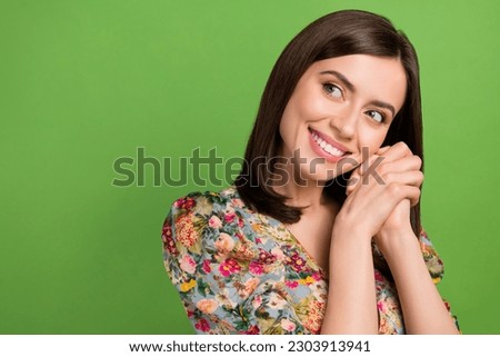 Photo of modest young attractive lady folded hands together look dreams empty space expect boyfriend gift isolated on green background