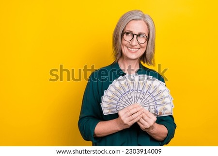 Photo of banker lady hold dollars money fan look empty space bank loan offer deposit savings isolated on shine color background