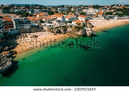 Drone aerial view of Praia da Rainha and Conceicao next to the historic city centre of Cascais, Portugal Royalty-Free Stock Photo #2303921819
