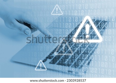 Cyber security. Man works on computer with alert sign