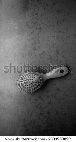 Hairbrush. Black and white photo of a hair brush. Royalty-Free Stock Photo #2303930899