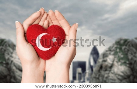 Human hands hold red heart with Turkey flag, Royalty-Free Stock Photo #2303936891