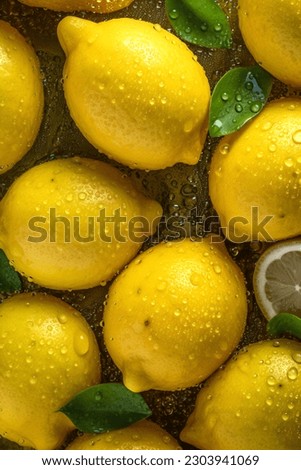 Creative fruits composition. Beautiful yellow lemons sliced half whole glistering with dew water droplet. flat lay top view. seamless macro closeup
 Royalty-Free Stock Photo #2303941069
