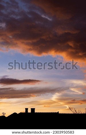 Colorful dramatic sunset with fluffy clouds after storm
