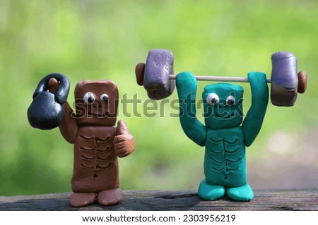 Zombie figures with toy dumbbells.