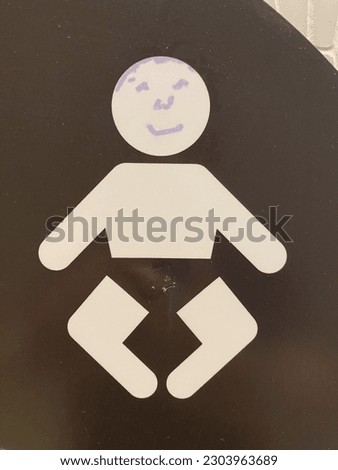 Bathroom male signage with a happy face drawn on it at a Rideau Centre shopping centre bathroom entrance.