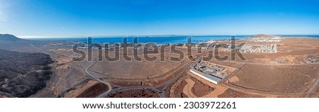 Drone panorama picture over Playa Blanca vacation village in Lanzarote with Fuerteventura in background