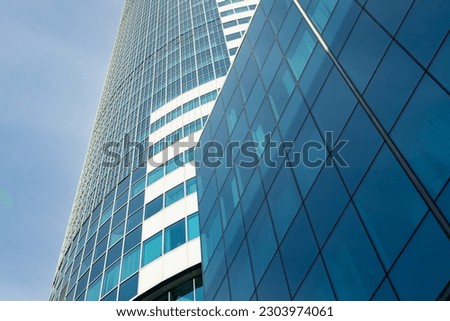 Glass office building against the sky close up
