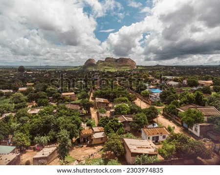 Drone shot of rock formation that looks like a face in a small rural town in Mozambique.