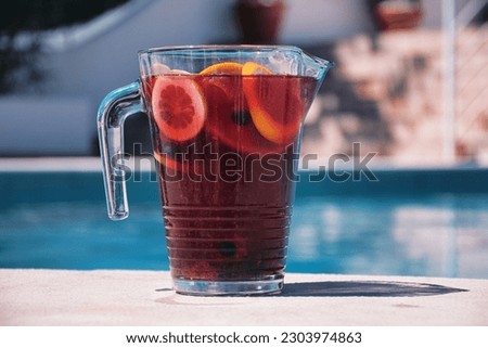 A jug of Sangria by the pool in Portugal. Royalty-Free Stock Photo #2303974863