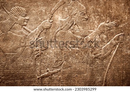 Sumerian wall relief, ancient cuneiform Sumerian text. Historical background on the theme of civilizations of Assyria, Mesopotamia, Babylon, interfluve, Sumerian. Overlay effect on old paper texture. Royalty-Free Stock Photo #2303985299