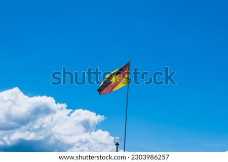 Sarawak flag waving against blue sky, flag of the Sarawak state, East Malaysia